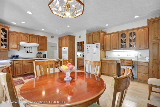 1823 Cricket Ln, East Lansing, MI 48823 - dining area featuring recessed lighting, light wood-type flooring, and a chandelier