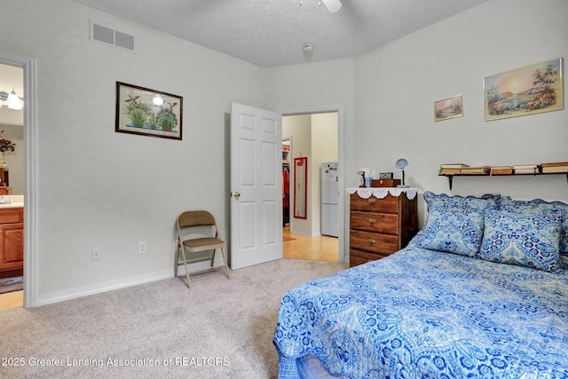 1823 Cricket Ln, East Lansing, MI 48823 - bedroom featuring light colored carpet, ensuite bathroom, ceiling fan, a textured ceiling, and freestanding refrigerator