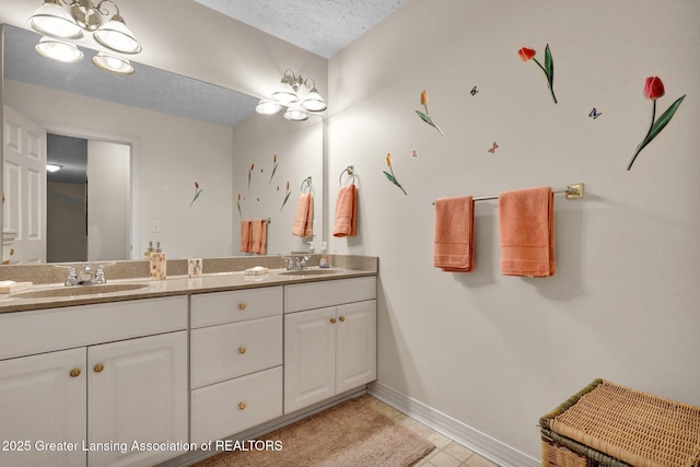1823 Cricket Ln, East Lansing, MI 48823 - bathroom with double vanity, a textured ceiling, and tile patterned floors