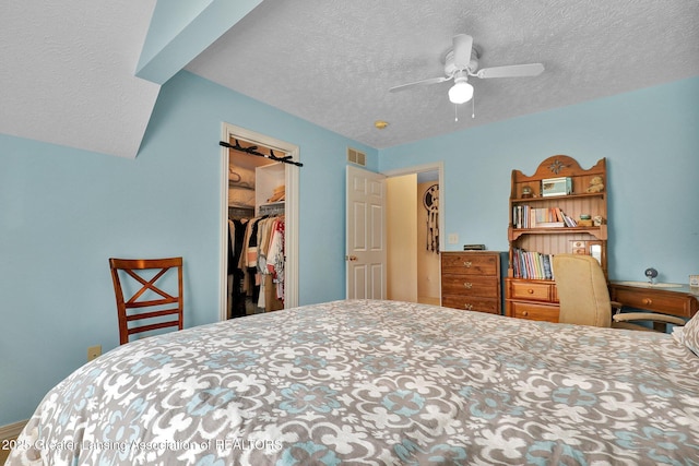 1823 Cricket Ln, East Lansing, MI 48823 - bedroom featuring a textured ceiling, a closet, a spacious closet, and ceiling fan
