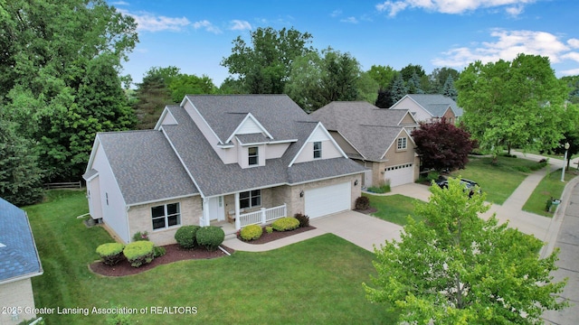 1823 Cricket Ln, East Lansing, MI 48823 - traditional-style home with a porch, concrete driveway, roof with shingles, and a front lawn