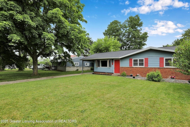 528 Thomas L Pkwy, Lansing, MI 48917 - ranch-style house featuring driveway, brick siding, a front yard, and a carport