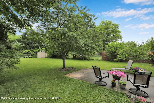 528 Thomas L Pkwy, Lansing, MI 48917 - fenced backyard featuring a patio area and a shed