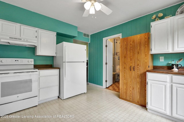 528 Thomas L Pkwy, Lansing, MI 48917 - kitchen with white appliances, under cabinet range hood, dark countertops, and light flooring