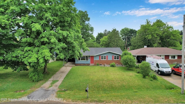 528 Thomas L Pkwy, Lansing, MI 48917 - ranch-style house with concrete driveway, a front lawn, and crawl space