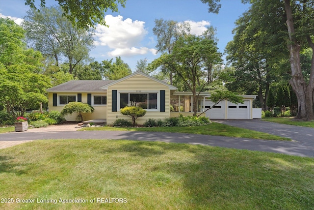 2391 Shawnee Trl, Okemos, MI 48864 - single story home with a garage, a front lawn, and driveway