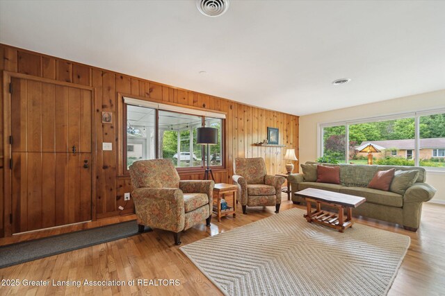 2391 Shawnee Trl, Okemos, MI 48864 - living area featuring wooden walls and light wood-style floors