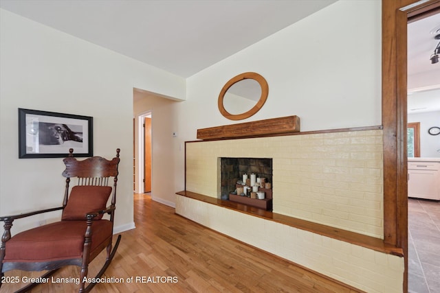 2391 Shawnee Trl, Okemos, MI 48864 - living area featuring wood finished floors and a brick fireplace