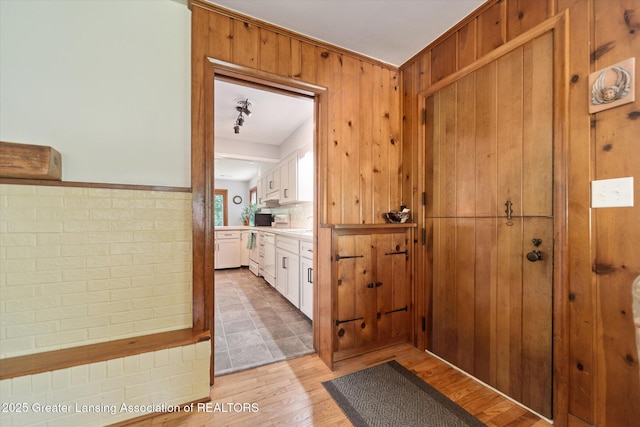 2391 Shawnee Trl, Okemos, MI 48864 - doorway featuring light wood-style floors and wood walls