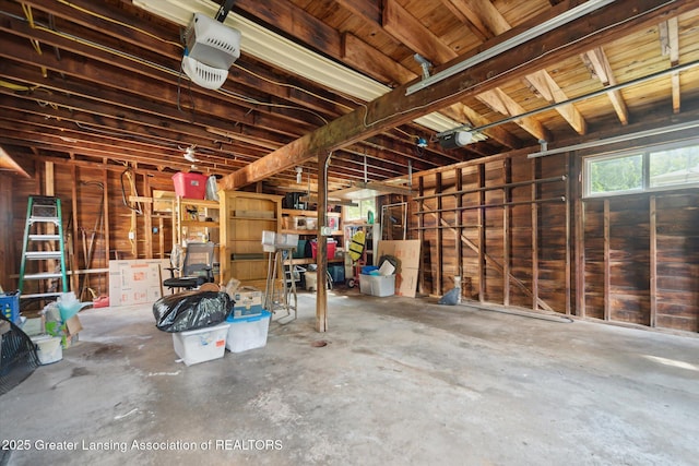 2391 Shawnee Trl, Okemos, MI 48864 - garage featuring a garage door opener and wooden walls