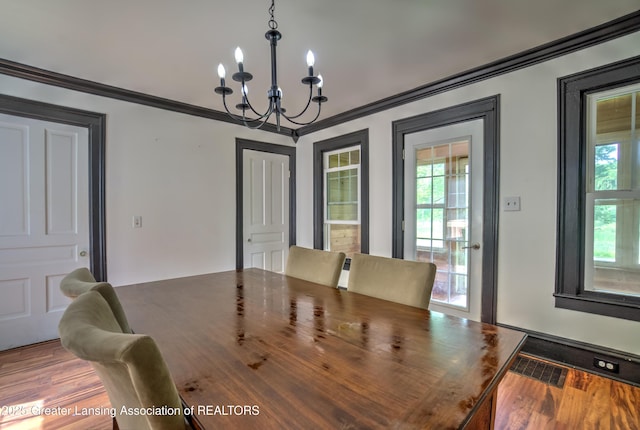 6631 Springport Rd, Jackson, MI 49201 - dining space with a chandelier and crown molding