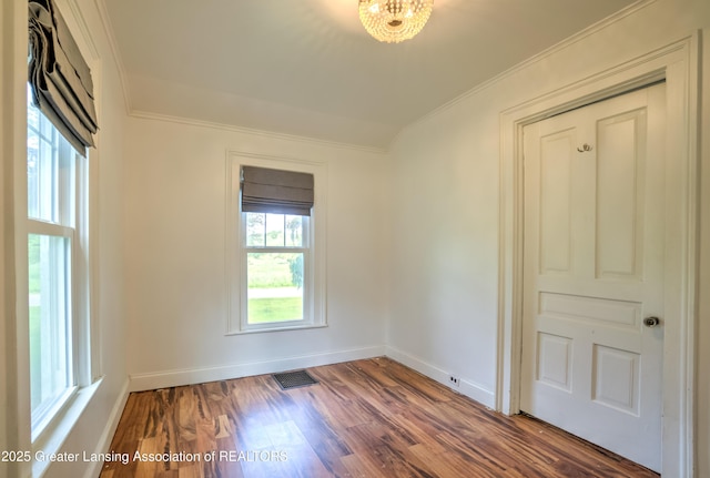 6631 Springport Rd, Jackson, MI 49201 - spare room with ornamental molding and wood finished floors