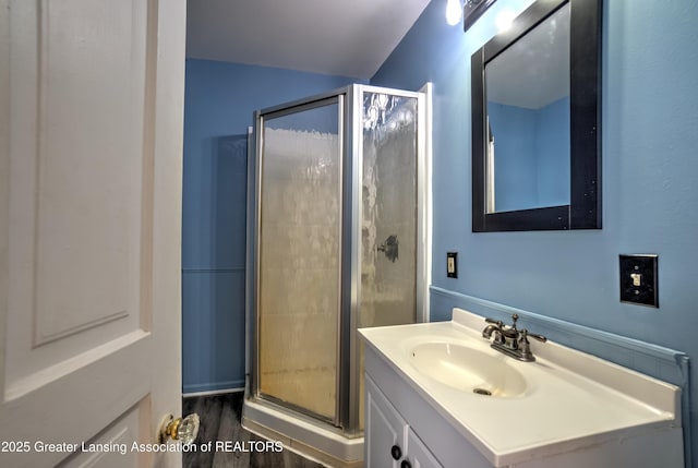 6631 Springport Rd, Jackson, MI 49201 - bathroom with a stall shower, vanity, and wood finished floors