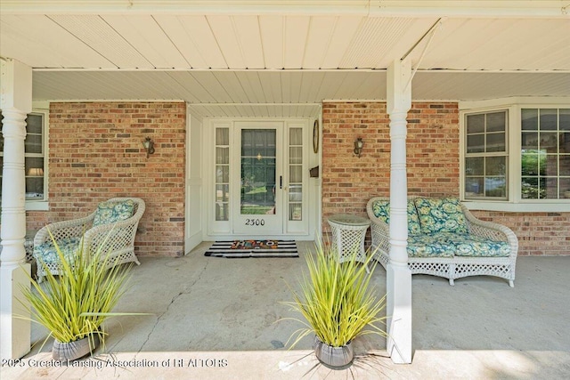 2300 Hampshire Rd, Lansing, MI 48911 - property entrance featuring covered porch and brick siding