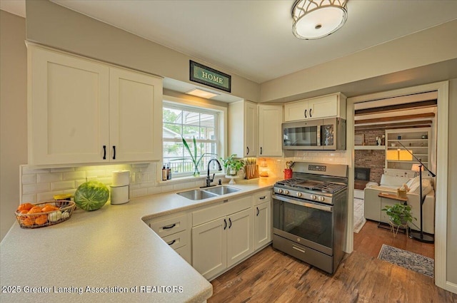 2300 Hampshire Rd, Lansing, MI 48911 - kitchen featuring appliances with stainless steel finishes, white cabinets, and light countertops