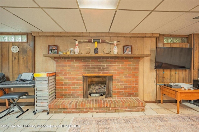 2300 Hampshire Rd, Lansing, MI 48911 - tiled living room featuring wooden walls, a brick fireplace, an office area, and a paneled ceiling