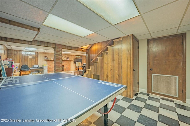2300 Hampshire Rd, Lansing, MI 48911 - playroom featuring tile patterned floors, wooden walls, and a paneled ceiling