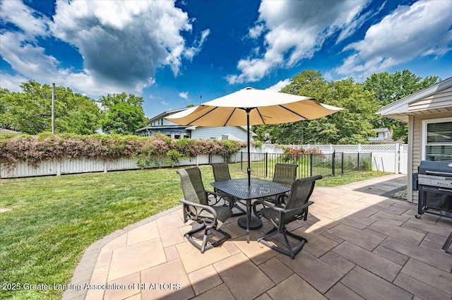 2300 Hampshire Rd, Lansing, MI 48911 - fenced backyard featuring a patio area, outdoor dining space, and area for grilling