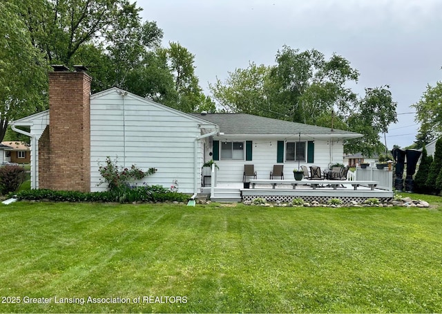 4624 Meaford St, Lansing, MI 48917 - rear view of house featuring a yard, a chimney, and a deck