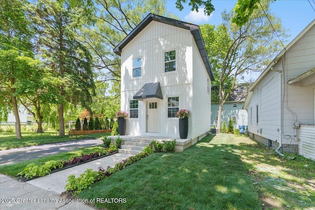 1033 May St, Lansing, MI 48906 - view of front of home featuring a front lawn and board and batten siding