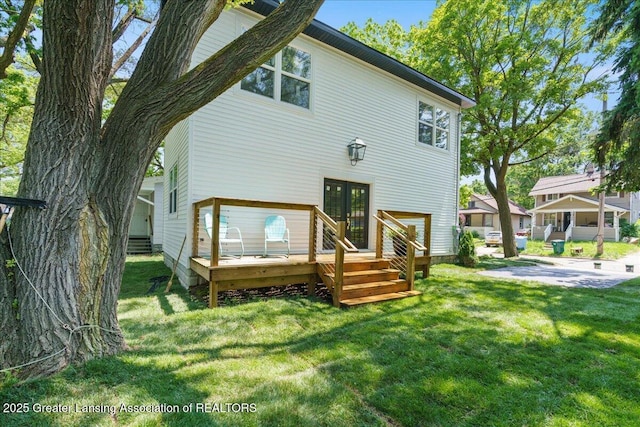 1033 May St, Lansing, MI 48906 - rear view of property with french doors, a deck, and a lawn