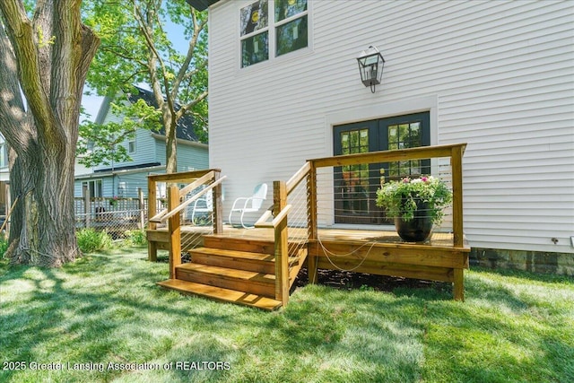 1033 May St, Lansing, MI 48906 - rear view of house featuring a wooden deck and french doors