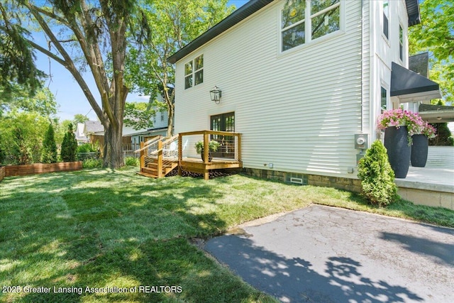 1033 May St, Lansing, MI 48906 - back of house with a deck, a yard, and a patio