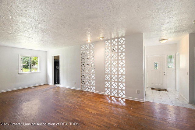 3739 Ridgefield Rd, Lansing, MI 48906 - unfurnished room with wood finished floors and a textured ceiling