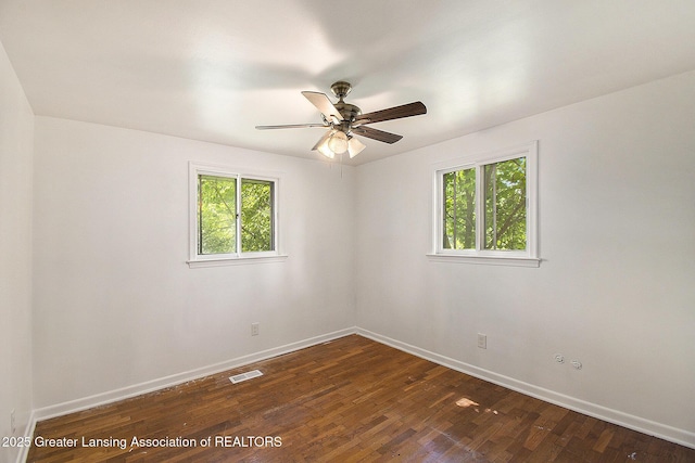 3739 Ridgefield Rd, Lansing, MI 48906 - spare room featuring dark wood-style floors and ceiling fan