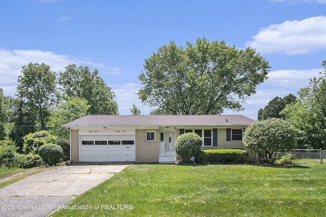 3739 Ridgefield Rd, Lansing, MI 48906 - view of front of home with an attached garage, brick siding, driveway, and a front lawn