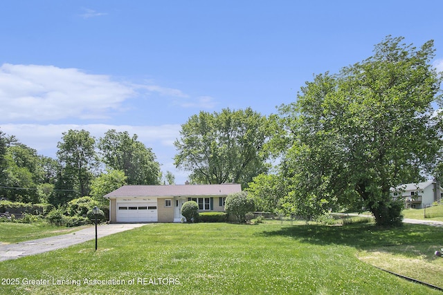 3739 Ridgefield Rd, Lansing, MI 48906 - ranch-style home with concrete driveway, a garage, and a front yard