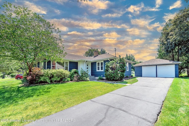 943 Lantern Hill Dr, East Lansing, MI 48823 - single story home with an outbuilding, a detached garage, a chimney, and a yard