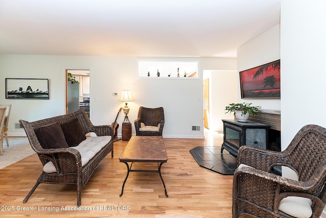943 Lantern Hill Dr, East Lansing, MI 48823 - living room featuring light wood-style floors and baseboards