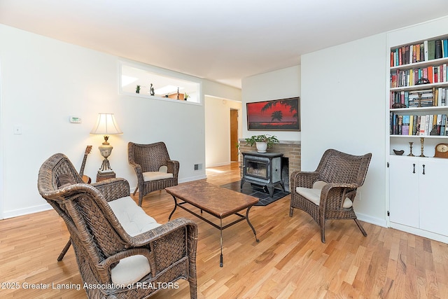 943 Lantern Hill Dr, East Lansing, MI 48823 - living area featuring a wood stove and light wood-type flooring