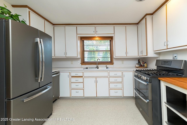 943 Lantern Hill Dr, East Lansing, MI 48823 - kitchen featuring stainless steel appliances, light countertops, and white cabinets
