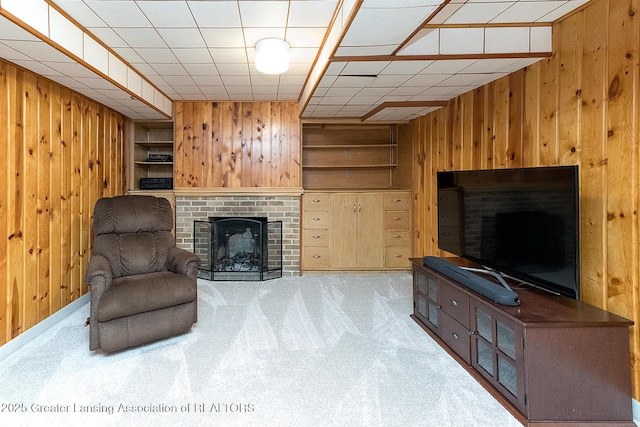 943 Lantern Hill Dr, East Lansing, MI 48823 - carpeted living room featuring wooden walls and a brick fireplace