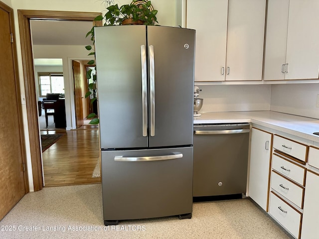 943 Lantern Hill Dr, East Lansing, MI 48823 - kitchen with appliances with stainless steel finishes, light countertops, and white cabinetry