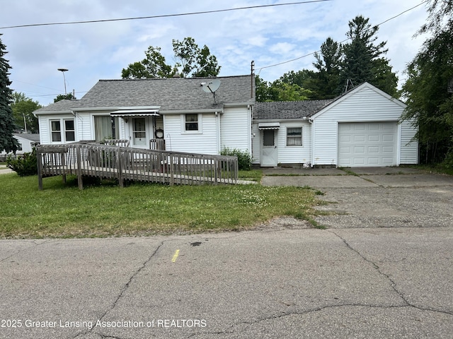 500 N Catherine St, Lansing, MI 48917 - view of front of home with concrete driveway, a front lawn, an attached garage, a deck, and a shingled roof