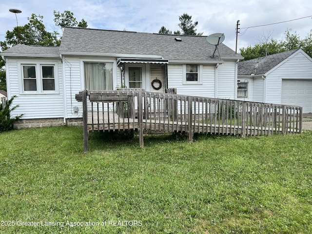500 N Catherine St, Lansing, MI 48917 - rear view of property featuring a deck, a lawn, and roof with shingles