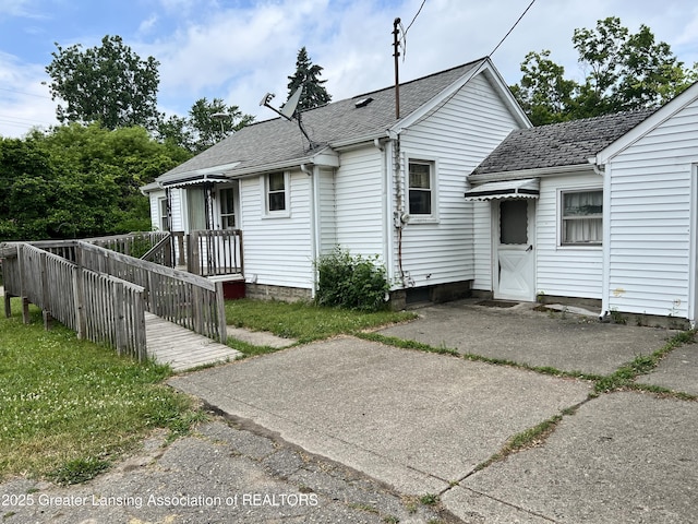 500 N Catherine St, Lansing, MI 48917 - rear view of property featuring roof with shingles