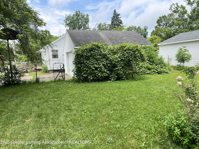 500 N Catherine St, Lansing, MI 48917 - view of yard featuring a garage
