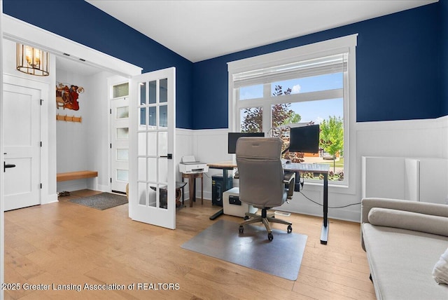 6102 Sleepy Hollow Ln, East Lansing, MI 48823 - office space with wainscoting, french doors, wood finished floors, and a decorative wall