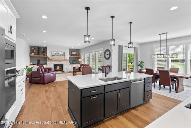 6102 Sleepy Hollow Ln, East Lansing, MI 48823 - kitchen with stainless steel appliances, light wood finished floors, white cabinetry, light countertops, and recessed lighting