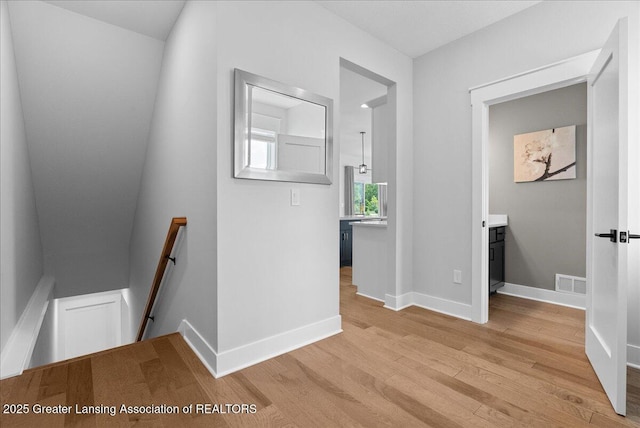 6102 Sleepy Hollow Ln, East Lansing, MI 48823 - corridor featuring an upstairs landing and light wood-style flooring