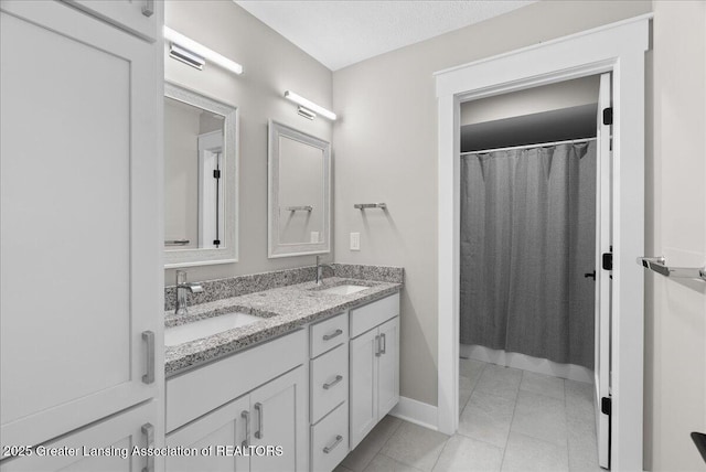 6102 Sleepy Hollow Ln, East Lansing, MI 48823 - full bathroom with double vanity, a shower with curtain, and tile patterned floors