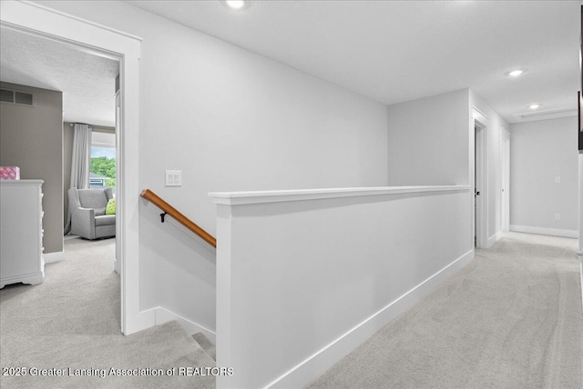 6102 Sleepy Hollow Ln, East Lansing, MI 48823 - corridor featuring carpet flooring, an upstairs landing, and recessed lighting