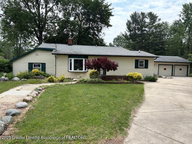 6321 Marywood Ave, Lansing, MI 48911 - single story home featuring a chimney, a front yard, driveway, and an outbuilding