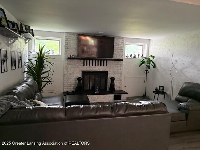 6321 Marywood Ave, Lansing, MI 48911 - living area featuring plenty of natural light, a fireplace, and wood finished floors