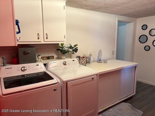 6321 Marywood Ave, Lansing, MI 48911 - laundry room featuring cabinet space, washing machine and clothes dryer, a textured ceiling, and dark wood-style flooring