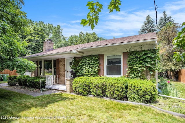 2782 Roseland Ave, East Lansing, MI 48823 - view of front of property featuring a chimney, a front lawn, brick siding, and covered porch